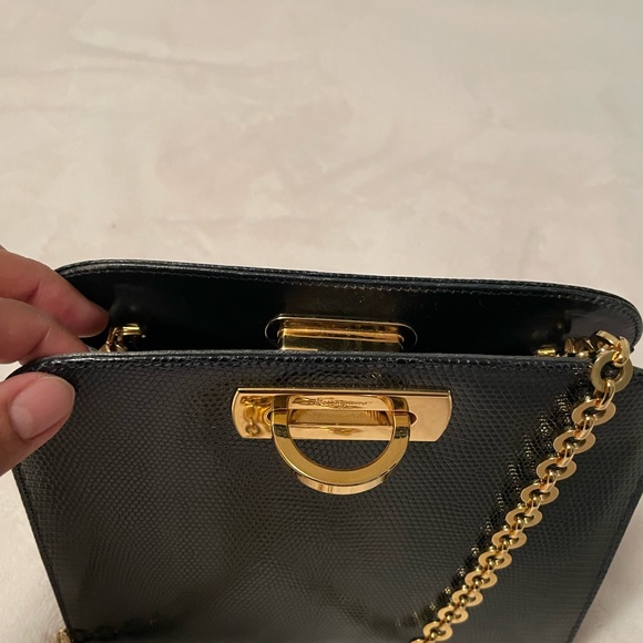Authentic Salvatore Ferragamo black leather bag with shiny gold metal handle. - Picture 2 of 11